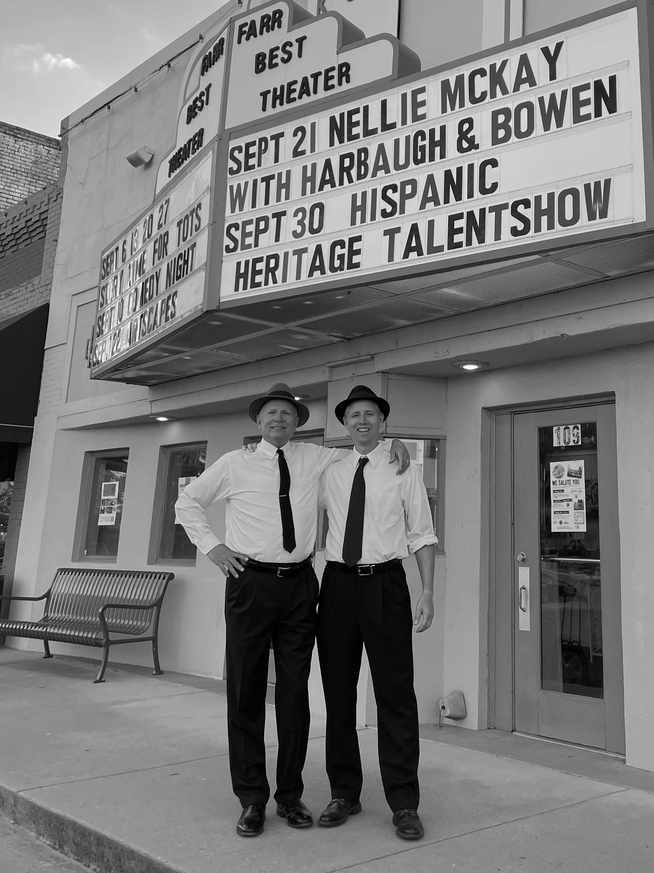 Harbaugh and Bowen standing in front of the Farr Best Theater in Mansfield, TX